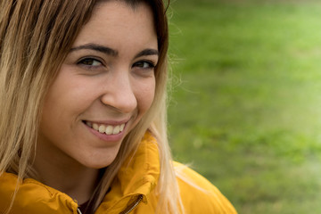 pretty young girl with a smile in the field in autumn