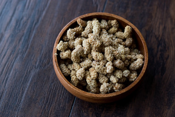 Sun Dried Mulberries in Wooden Bowl.