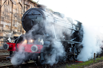 An 8F class locomotive steaming in a siding at Carlisle Station, Cumbria, England, UK.