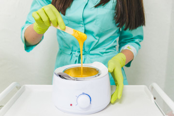 preparation for sugaring. heat up. stick. cosmetology center concept
