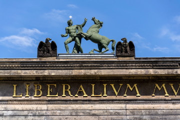 Fototapeta premium Horse with man bronze sculpture on the roof of Old Museum - Altes Museum in Berlin, Germany