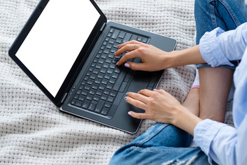 online business. woman working from home. making money on the internet. white empty laptop screen for advertisement.