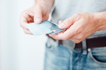 credit card loan. online borrowing. financial banking operation. man holding plastic cards.
