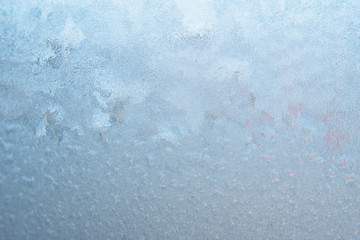 Winter background, frozen glass from strong frost, ice texture on the window