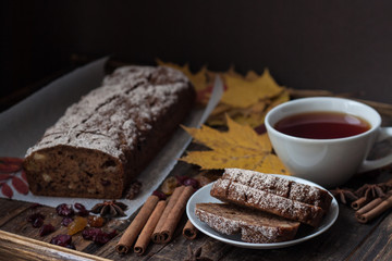 Homemade banana bread with anis star and cinnamon on a dark wooden background