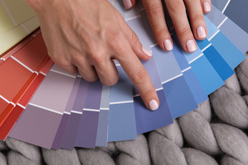 Home improvement. Woman choosing colors for painting pallette close up
