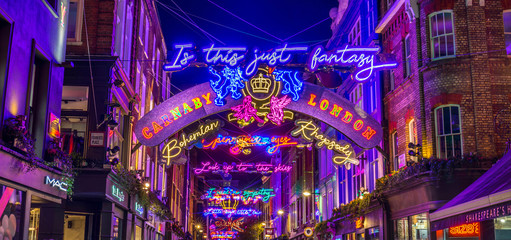 Lights down Carnaby Street in London during the Christmas Season. Large amounts of people can be seen.