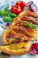 Open vegetable pie sliced into pieces.