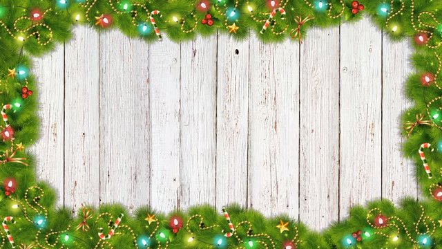 Christmas New Year decoration composition top view of green fir tree branches with stars, candy and festive lights on white wooden texture 4K