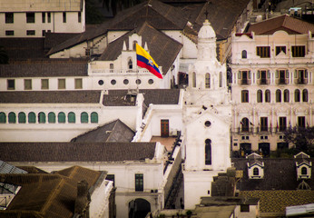 Fototapeta premium Ecuadorian flag waving in the historic district of the city of Quito
