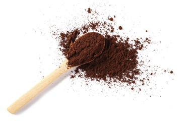 Instant coffee and wooden spoon, pile of powdered isolated on white background, top view