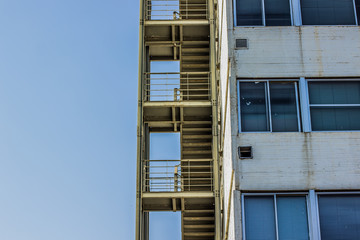 metal stairs construction shape on high  concrete common house wall and urban architecture concept