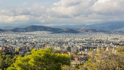 Obraz premium panorama of big capital city aerial shot from above in cloudy rainy weather time with mountain ridge landscape view on horizon background