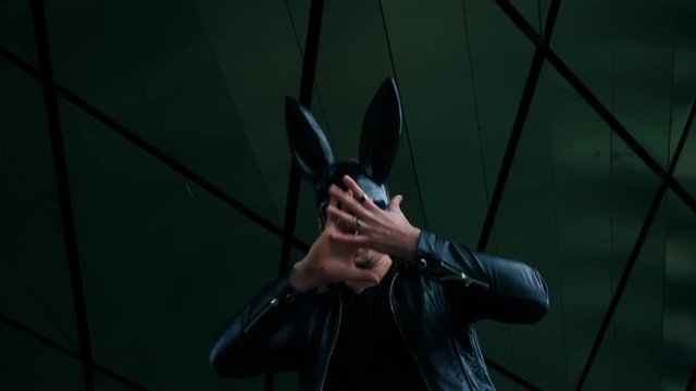 Man in the mask of a hare is dancing