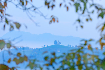 Landscape in Slovenia, nature in Europe.  Foggy Triglav Alps with forest, travel in Slovenia. Beautiful sunrise with blue sky, green nature.