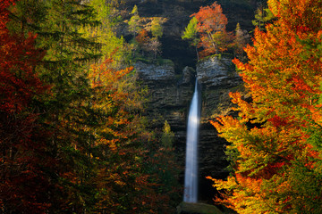Autumn landscape in Slovenia, nature in Europe.  Pericnik waterfall, Triglav Alps with orange...