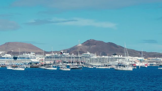 sailing boats are leaving the city marina for the atlantic crossing regatta race on a sunny day