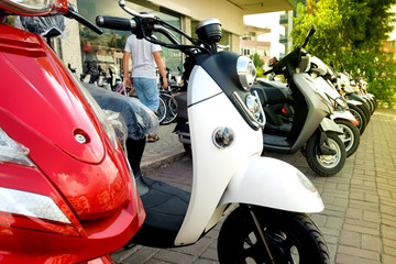 New scooters exhibited for sale on the street near the store