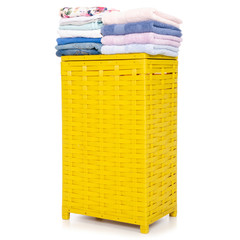 Yellow laundry basket with towel and clothing on white background isolation