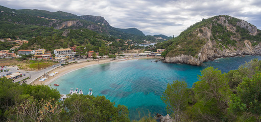 Obraz premium Panoramic view on beautiful Paleokastritsa bay with sand beach, forest, hills and rocks, Corfu, Kerkyra, Greece