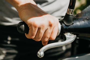 The tourist is going to use an electric scooter. Close-up hand. Popular vehicle in Berlin in...