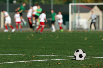 Young boys playing a football match and empty space for text