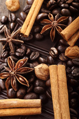 Christmas decor with dark chocolate coffee beans cinnamon nuts and star anise and empty place for text