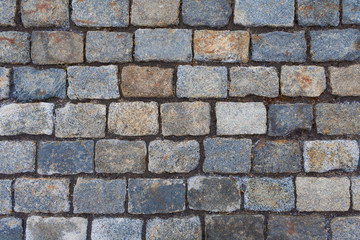 Top view on a old stone pavement (texture,  background, close up)
