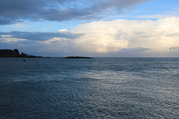 Obraz premium Scenic view of the Irish Sea on a cloudy day. Island on the horizon.