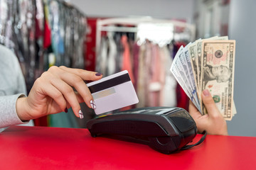 Female hands with dollar banknotes and credit card