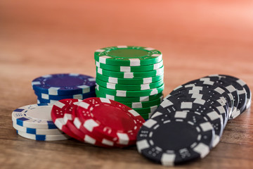 Poker chips on wooden desk, gambling concept