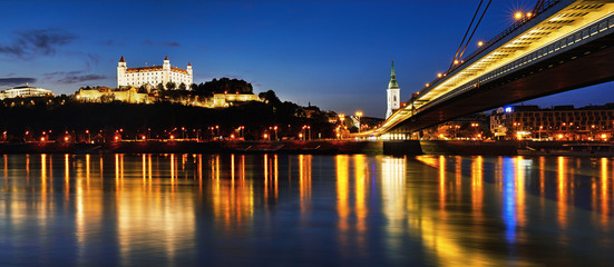 Fototapeta na wymiar BRATISLAVA, SLOVAKIA - May 5th, 2018: Panoramic view to Bratislava castle, SNP Bridge, Hotel Devin and St. Martin cathedral across Donau in the evening