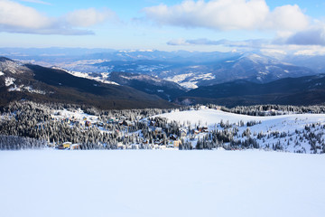 Panoramic view of Dragobrat ski resort from above. Mountain winter snowy landscape from ski slope....