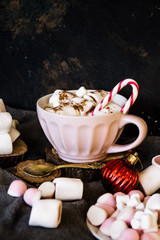 Good New Year spirit. Coffee with marshmallows and cinnamon. Candy canes. Pink mug. Cooking yourself. Home comfort. New Year. Christmas time. Winter mood.