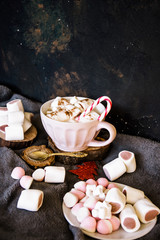 Good New Year spirit. Coffee with marshmallows and cinnamon. Candy canes. Pink mug. Cooking yourself. Home comfort. New Year. Christmas time. Winter mood.