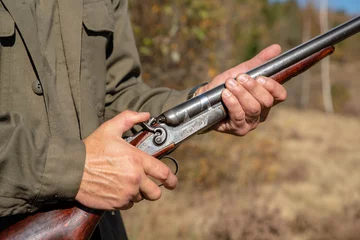 Fotobehang Hunter with horizontal double-barreled shotgun, pull the trigger, © dero2084