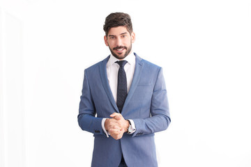 Businessman standing at isolated white background and wearing suit