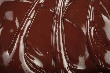 Melted chocolate swirl as a background closeup