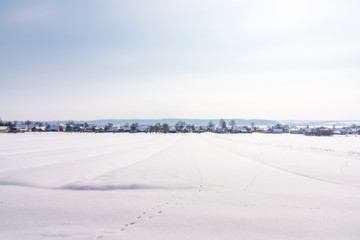 Fototapeta na wymiar Winter landscape, view of village from afar, Western Ukraine
