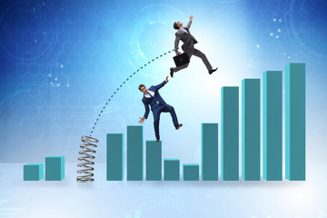 Businessman outperforming his competition jumping over