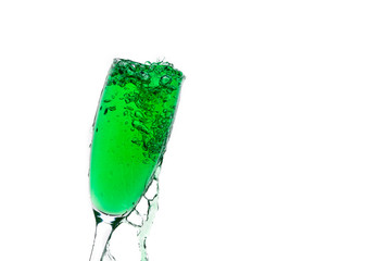 Green liquid is filled in a transparent glass on an isolated background.