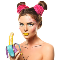 Beautiful model with creative pop art makeup holding banana