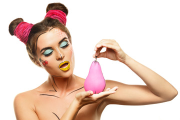 Beautiful model with creative pop art makeup holding pear fruit o