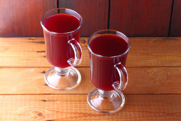 Mulled wine on wooden boards. Christmas mulled wine in glass cups. Alcoholic drink of wine and...