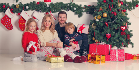 Obraz na płótnie Canvas Cheerful family with Christmas gifts