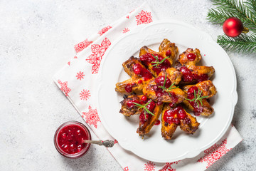 Baked chicken wings in cranberry sauce. 