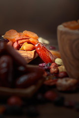 Various dried fruits and nuts in wooden dish.