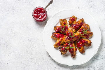 Baked chicken wings in cranberry sauce top view. 
