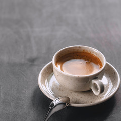 macro photo. light cup of black coffee with chocolate on the rustic table from a height. bokeh