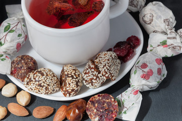 cup of strawberry tea with handmade candies